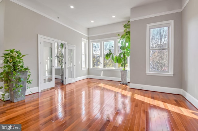 interior space featuring ornamental molding, french doors, and light hardwood / wood-style flooring