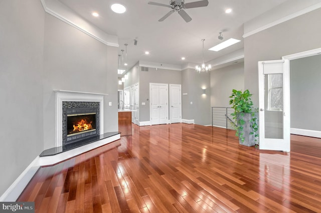 unfurnished living room featuring hardwood / wood-style floors, ornamental molding, and a fireplace