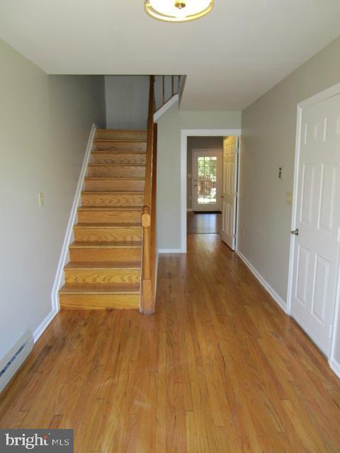 stairway featuring hardwood / wood-style floors