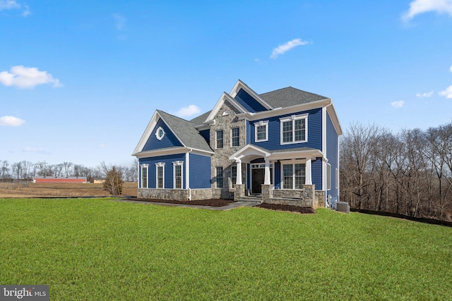 view of front of property with a porch, cooling unit, and a front yard