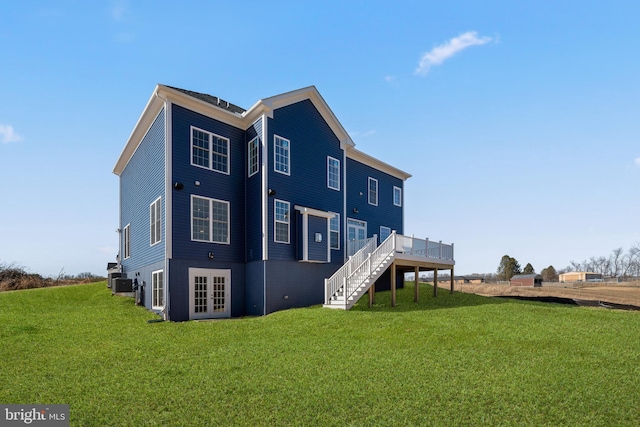 back of house with french doors, a yard, cooling unit, and a wooden deck