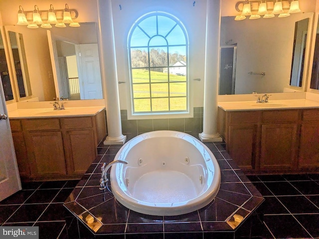 bathroom featuring ornate columns, tile patterned flooring, and vanity