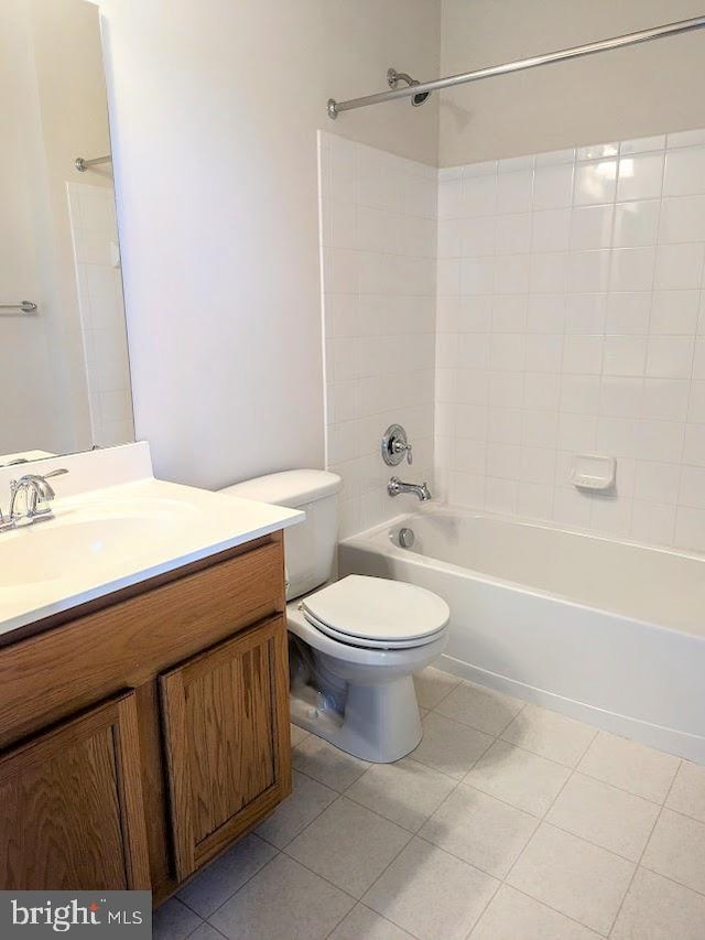 full bathroom with tile patterned flooring, vanity, toilet, and tiled shower / bath