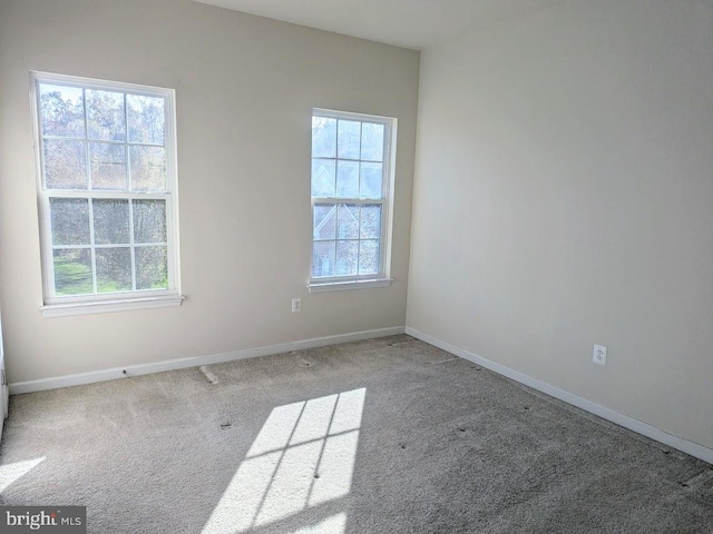 carpeted spare room with a healthy amount of sunlight