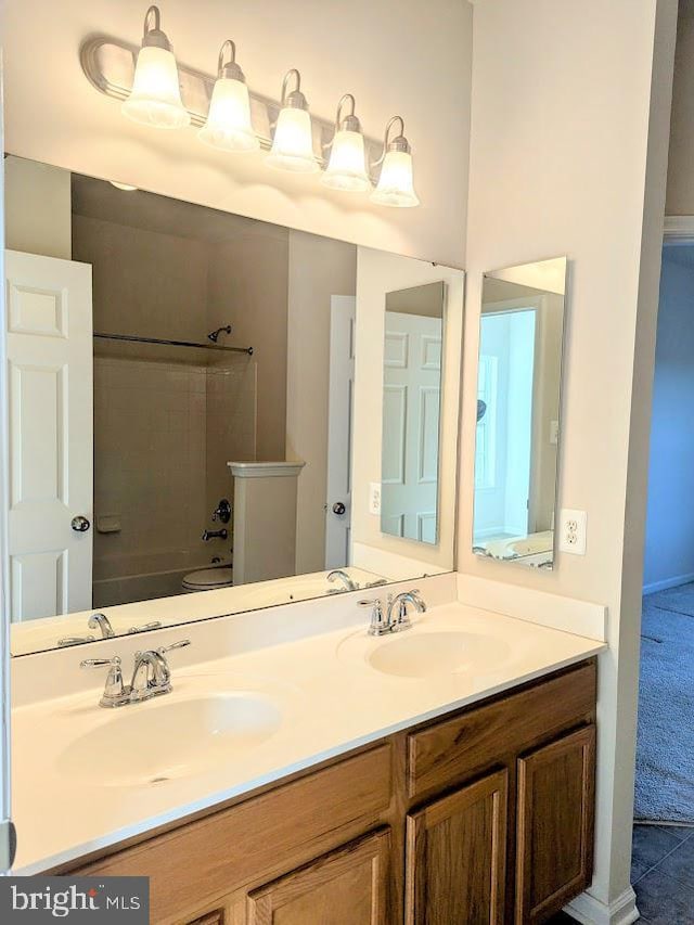 bathroom featuring tile patterned flooring, vanity, and tub / shower combination