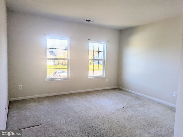 spare room featuring light colored carpet