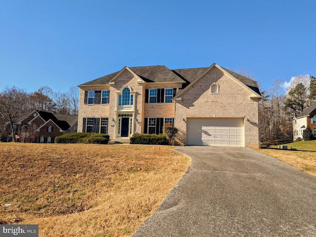 view of front of property featuring a garage and a front yard