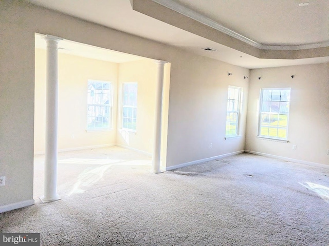 empty room featuring decorative columns and light carpet