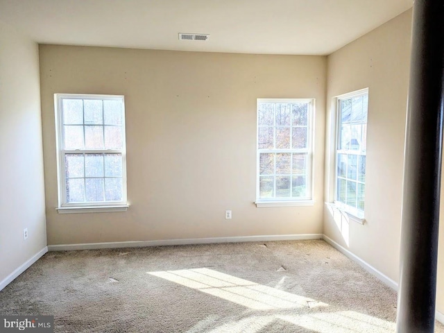 empty room featuring light carpet