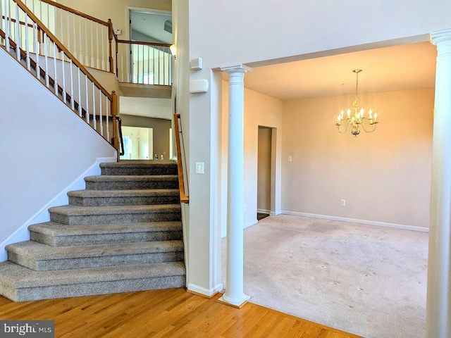 stairway with a chandelier and hardwood / wood-style flooring