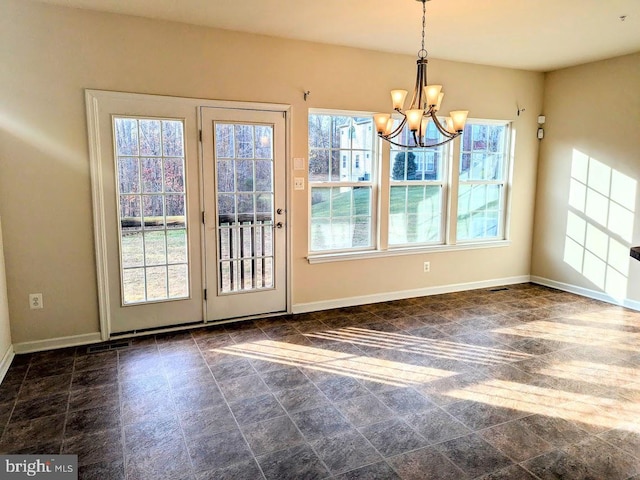 unfurnished dining area with a chandelier