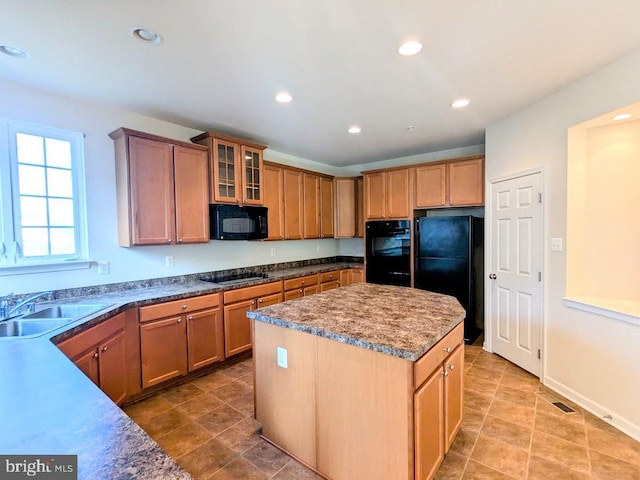 kitchen with sink, a kitchen island, and black appliances