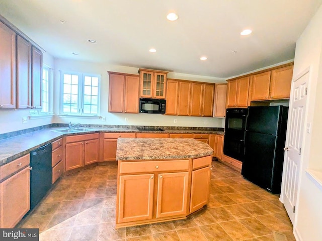 kitchen featuring light tile patterned flooring, sink, a kitchen island, and black appliances