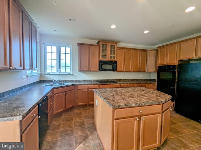 kitchen featuring black appliances, a kitchen island, and sink