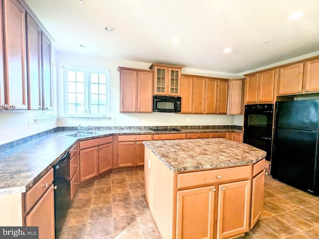 kitchen with black appliances, a kitchen island, and sink