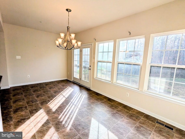 unfurnished dining area featuring a notable chandelier