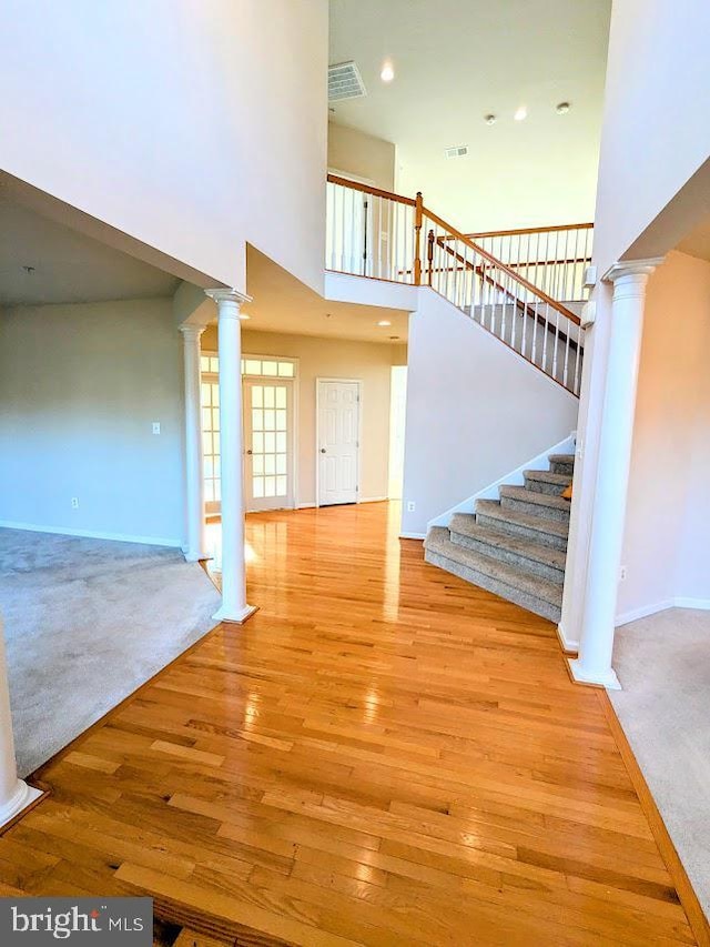 interior space featuring carpet floors and a towering ceiling