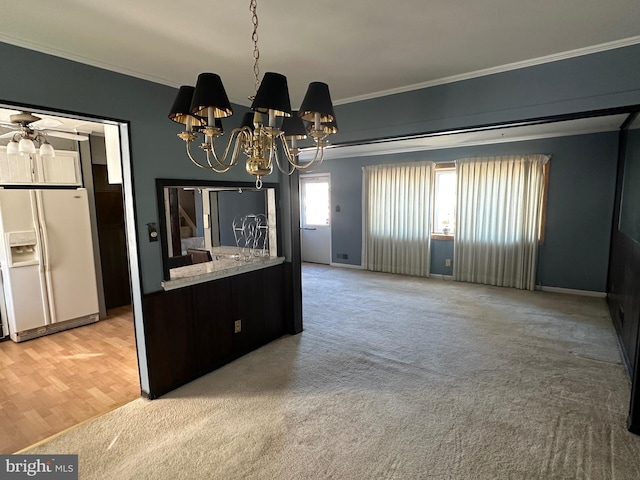 unfurnished dining area featuring carpet, ceiling fan with notable chandelier, and ornamental molding