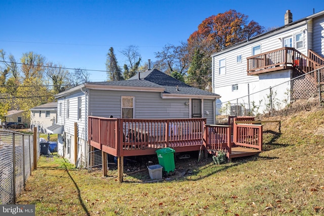 back of house featuring a yard and a wooden deck