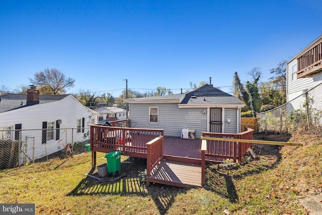 back of house with a lawn and a wooden deck