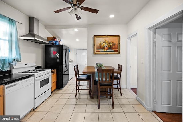 kitchen featuring ceiling fan, white appliances, wall chimney range hood, and light tile patterned floors