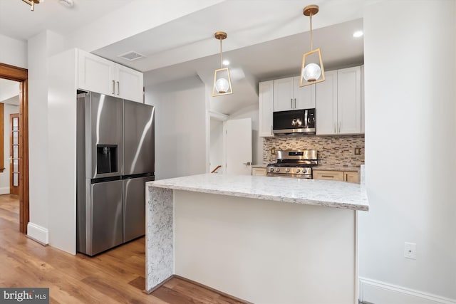 kitchen featuring light stone countertops, appliances with stainless steel finishes, light wood-type flooring, and white cabinetry