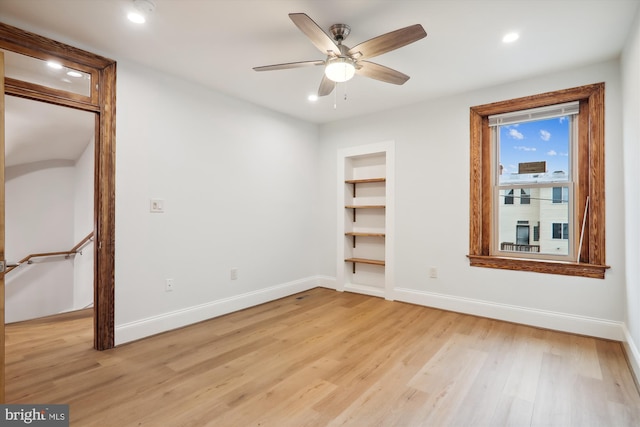 unfurnished room featuring ceiling fan and light wood-type flooring