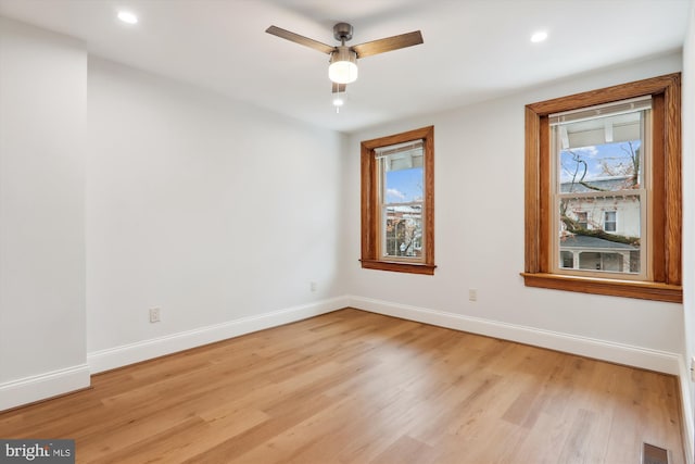 unfurnished room with ceiling fan and light hardwood / wood-style flooring