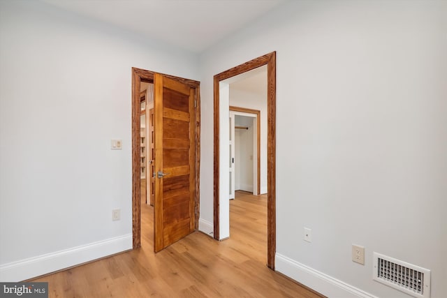 corridor with light hardwood / wood-style floors