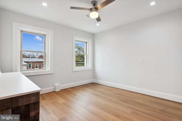 unfurnished dining area featuring ceiling fan and light hardwood / wood-style floors