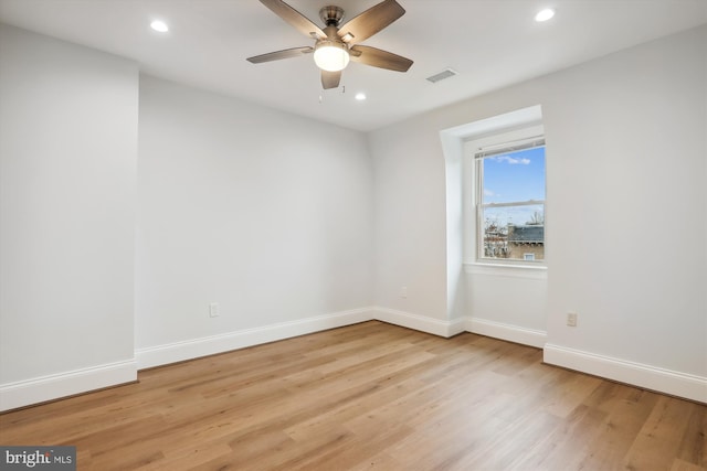 spare room with light hardwood / wood-style floors and ceiling fan