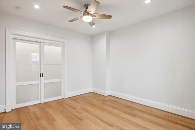 empty room featuring ceiling fan and light hardwood / wood-style flooring