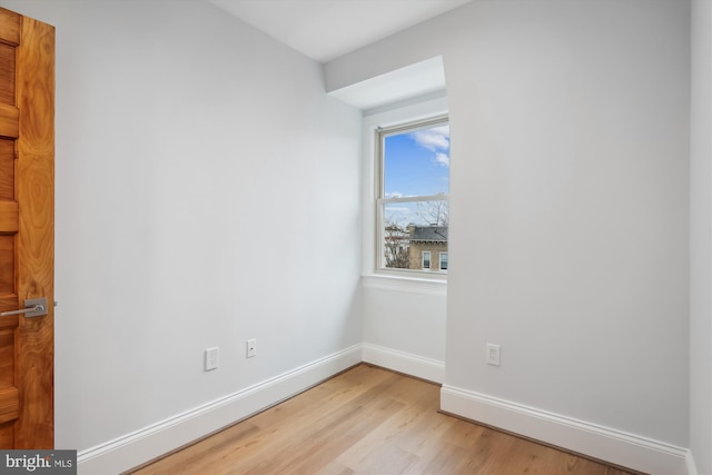 empty room with light hardwood / wood-style floors