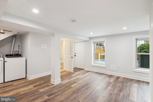 laundry area with hardwood / wood-style floors and washer and clothes dryer