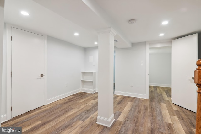 basement with light hardwood / wood-style flooring