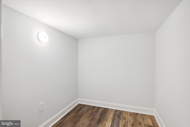 empty room with dark hardwood / wood-style flooring