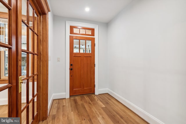 foyer entrance with a healthy amount of sunlight and light hardwood / wood-style floors