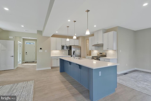 kitchen featuring light hardwood / wood-style floors, white cabinetry, a large island with sink, and appliances with stainless steel finishes