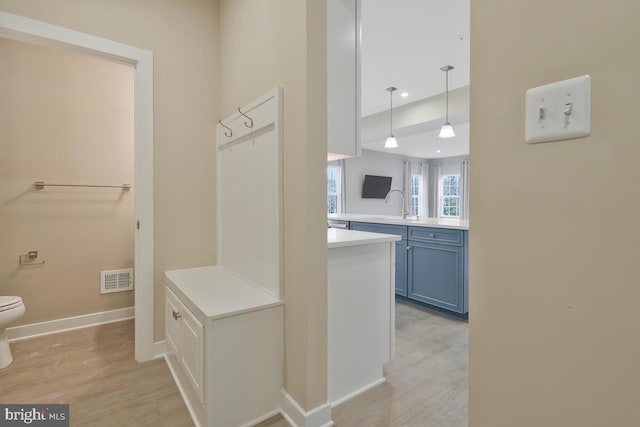 interior space with sink and light hardwood / wood-style flooring