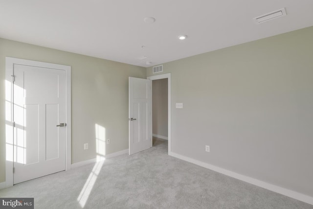 unfurnished bedroom featuring light colored carpet