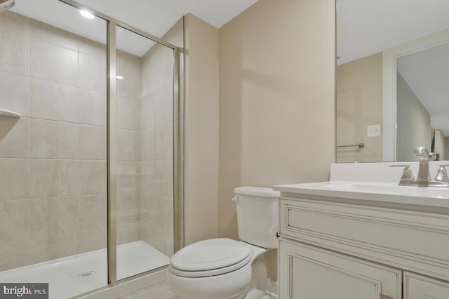 bathroom with vanity, toilet, and a shower with shower door