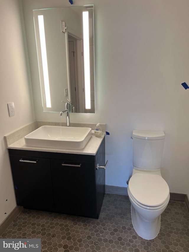 70 N N St SE Unit N505, Washington, DC 20003 - bathroom featuring baseboards, vanity, toilet, and tile patterned flooring