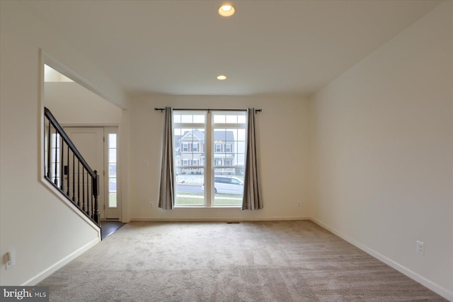 interior space featuring light carpet and a wealth of natural light