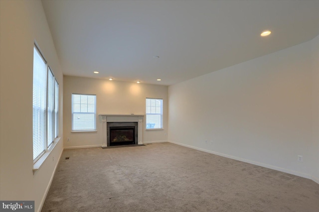 unfurnished living room with light colored carpet