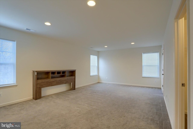 unfurnished living room with light colored carpet