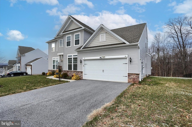 view of front facade with a front yard and a garage