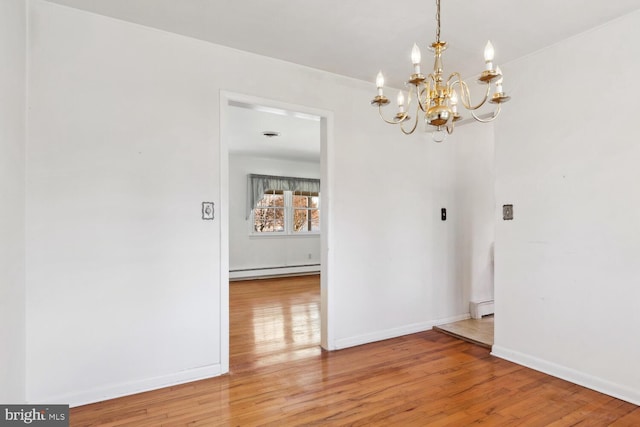 unfurnished dining area with baseboard heating, an inviting chandelier, and hardwood / wood-style flooring