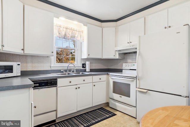 kitchen with tasteful backsplash, sink, white cabinets, and white appliances