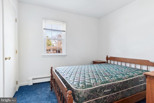 bedroom featuring dark colored carpet and a baseboard heating unit