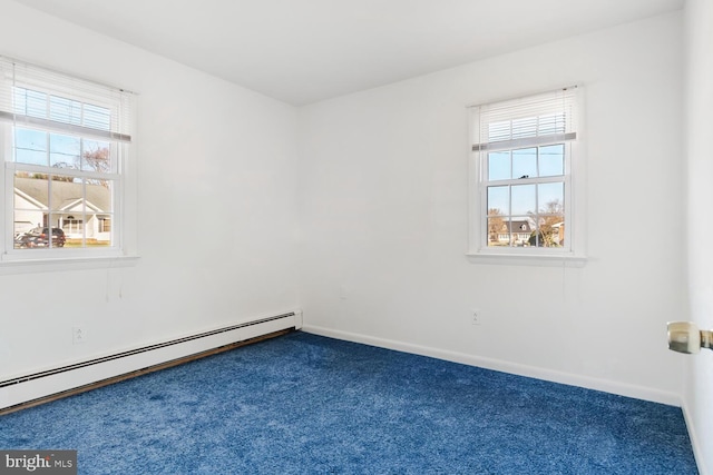 unfurnished room with carpet floors, a wealth of natural light, and a baseboard radiator